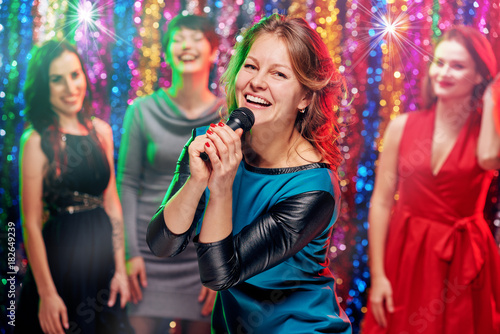 Smiling women in karaoke