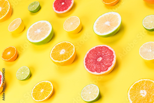background with cut half of citrus fruit on a yellow table