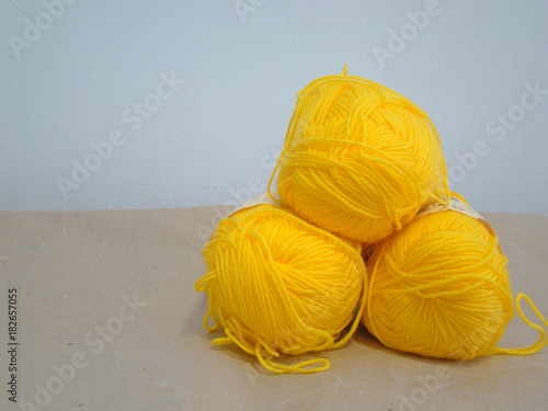 Wallpaper Mural Yellow yarn on a white wall background Torontodigital.ca