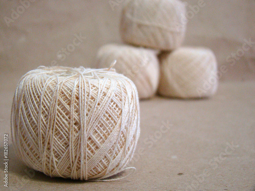 Wallpaper Mural Beads of beige yarn on gray paper close up Torontodigital.ca