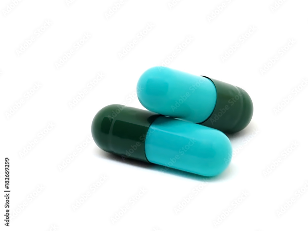 Medical capsules (Green-Blue) on white background. healthy product concept. Medical capsules (Green-Blue) on white background. healthy product concept.