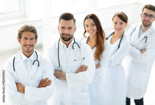 medical team standing with arms crossed on a white background