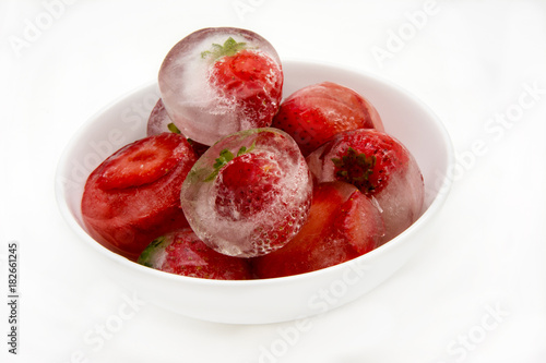 Ice cubes with frozen strawberries