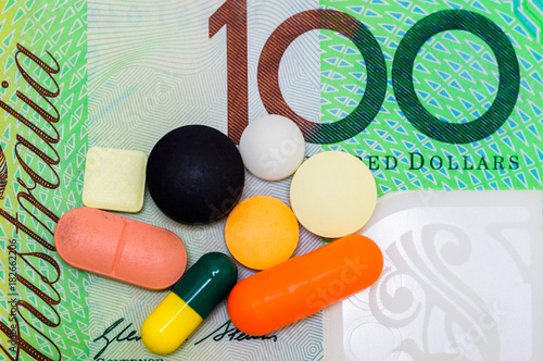 australian dollar with medication isolated on white.medical concept