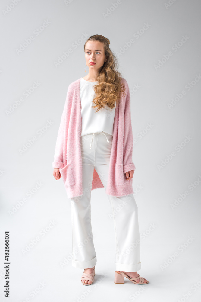 confident girl in trendy clothes standing and looking away on white confident girl in trendy clothes standing and looking away on white