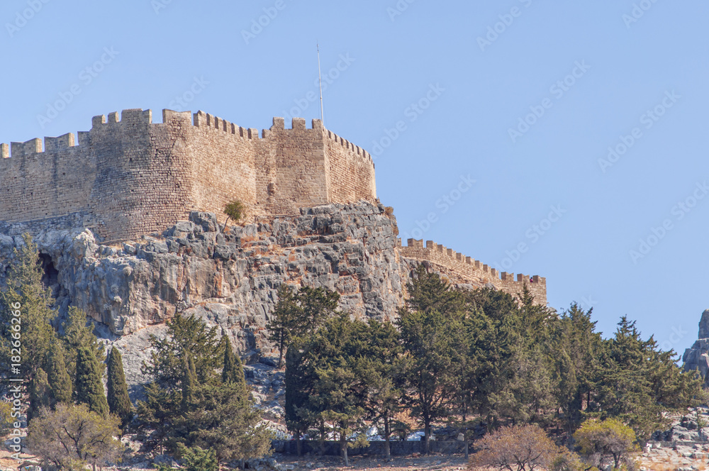 Summer bottom cliff view Acropolis of Lindos of Rhodes with big blue sky