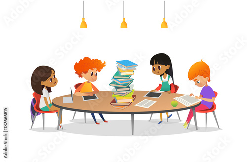 Group of school children sitting around circular table with large pile of books on it, reading and preparing for lesson. Multiracial kids at library. Modern vector illustration for banner, poster.