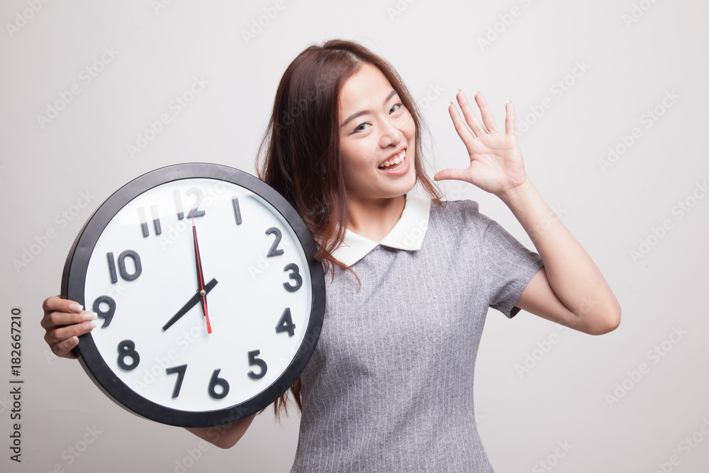 Happy Young Asian woman with a clock. Happy Young Asian woman with a clock.