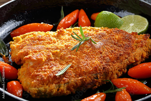 tasty fried breaded white fish steak photo