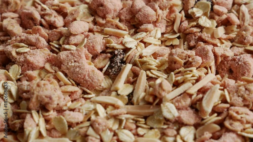 Close up of Strawberry Granola Oat Cereal textured with Almond and Raisin for Healthy Breakfast and Snack. Close up of Strawberry Granola Oat Cereal textured with Almond and Raisin for Healthy Breakfast and Snack.