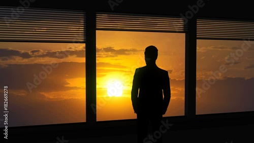 The man stand near a window on the bright sun background. time lapse