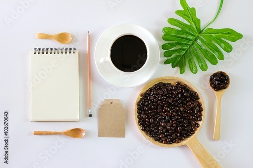 Flat lay photo with Notebook, Coffee cup, Pen, wooden spoon, Coffee bean and cactus isolated on white background