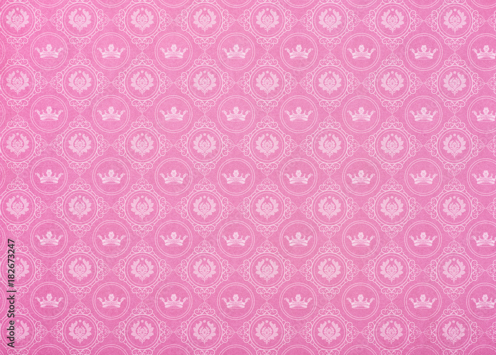 set of crowns and ornaments in circles on pink