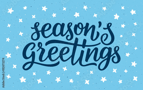 Seasons greetings calligraphy lettering text on blue background with white doodle stars. Retro greeting card for Christmas and New Year holidays. Vector background