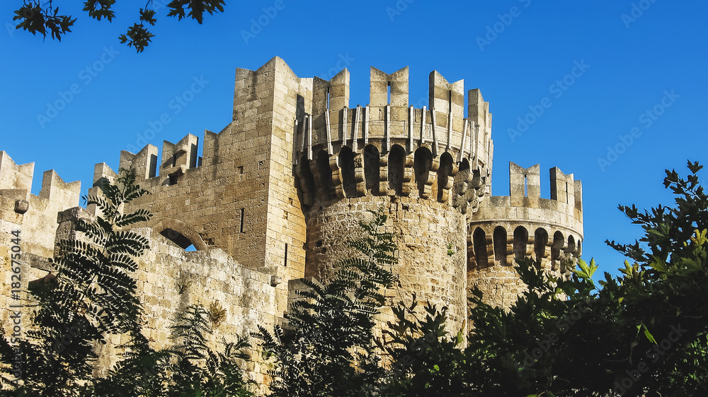 The Palace of the Grand Master of the Knights of Rhodes, close-up view. Rhodes, Greece. A part of medieval wall, surrounding the old town Rhodes. Historical fortifications, castle tower