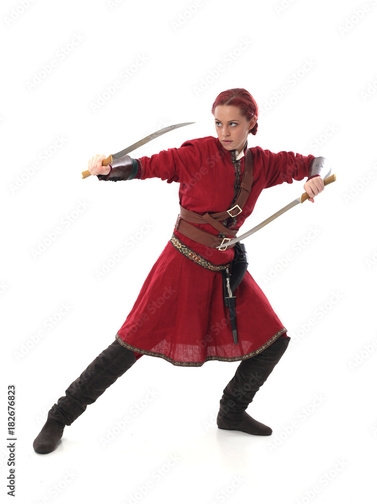 portrait of red haired girl wearing red medieval out fit, studio background. portrait of red haired girl wearing red medieval out fit, studio background.