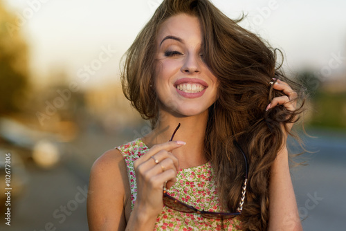 Beautiful Young Woman Outdoors. Enjoy Nature. Healthy Smiling Girl in sunset light
