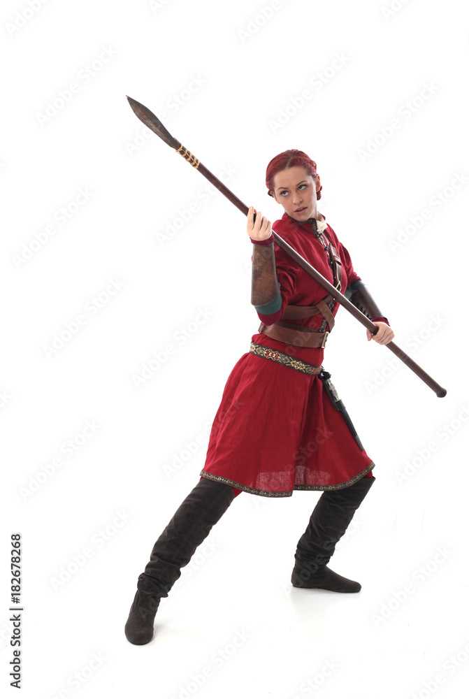 portrait of a red haired girl wearing medieval warrior outfit, studio background. portrait of a red haired girl wearing medieval warrior outfit, studio background.