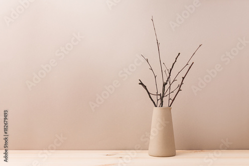 Ceramic vase with decorative branches photo