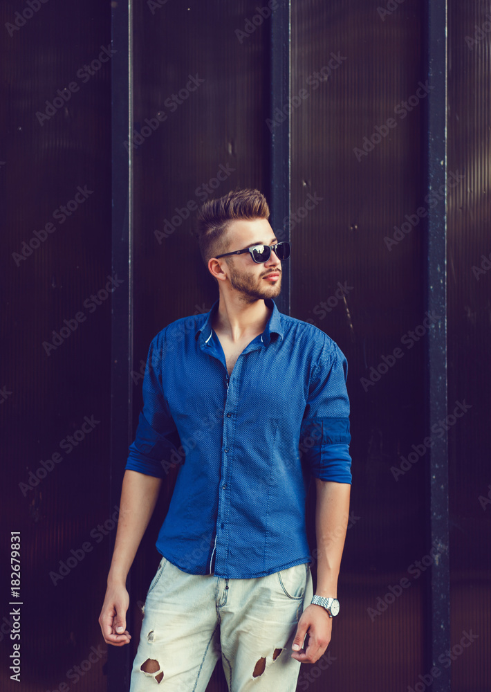 Obraz premium handsome young man standing near wall
