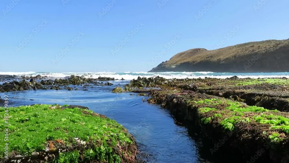 Incoming tidal waves over rocks.