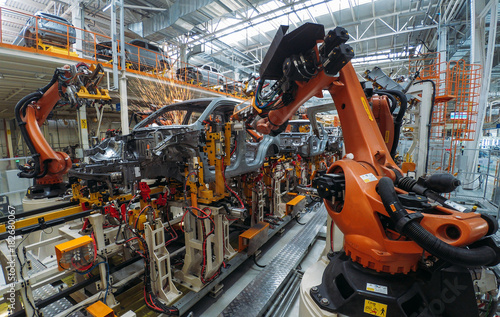 Фотография Automobile plant, welding process, modern production of cars, robot equipment, automated production line