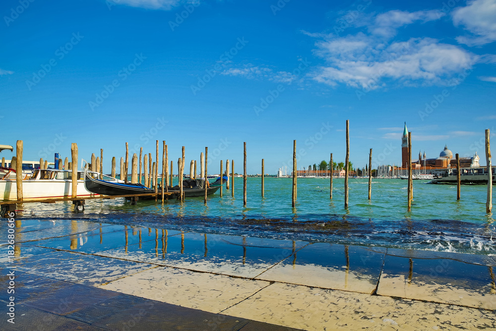 Landscape view of Adriatic Sea with boats and historic buildings in Venice, Italy, Europe.