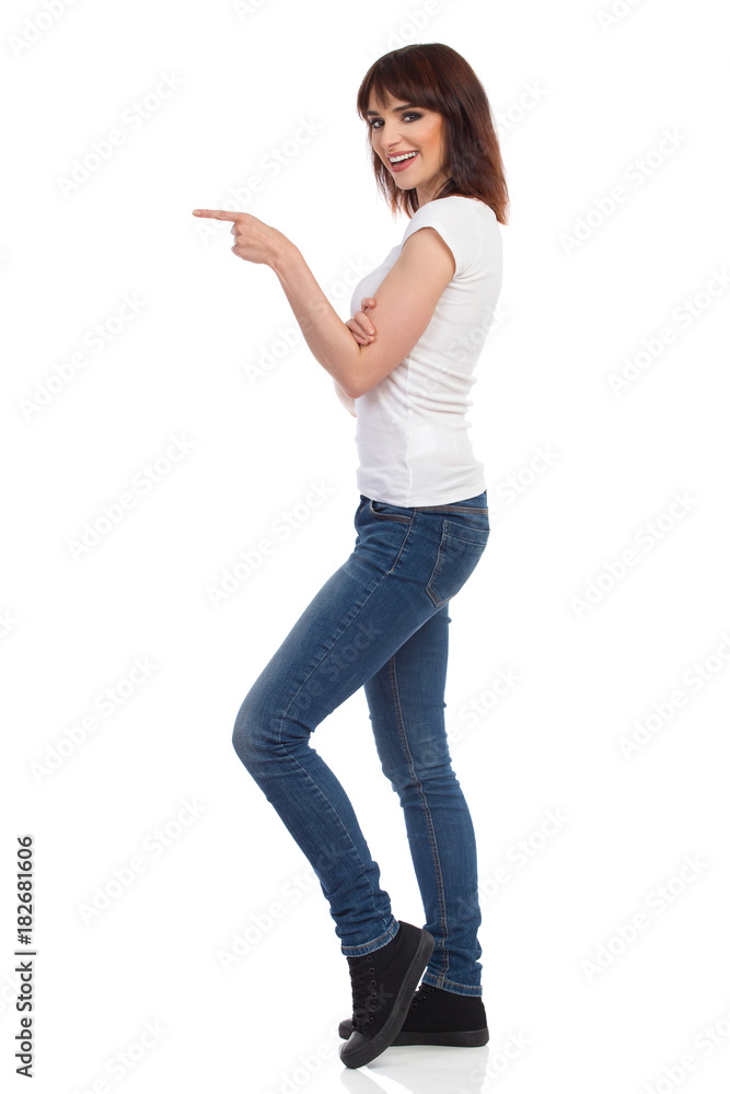 Smiling Young Woman Is Looking At Camera, Pointing And Talking Smiling Young Woman Is Looking At Camera, Pointing And Talking