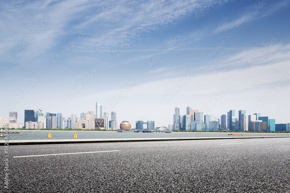 empty asphalt road with modern cityscape empty asphalt road with modern cityscape