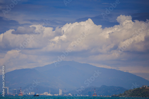 View of Resort City against Mountain Azure Sea Sky Clouds