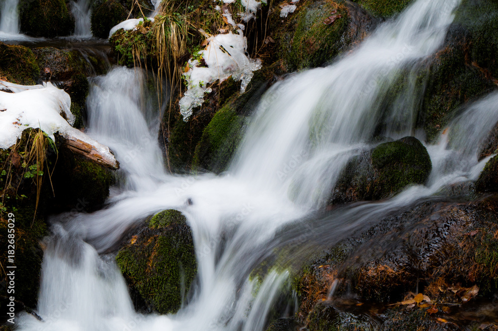 Small brook rushing down through the boulders in the Austrian Alps (long exposure) Small brook rushing down through the boulders in the Austrian Alps (long exposure)