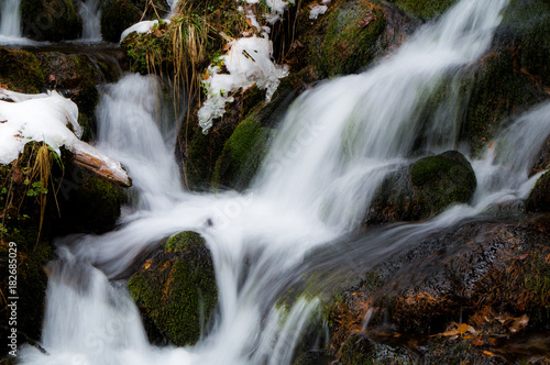 Small brook rushing down through the boulders in the Austrian Alps  long exposure 