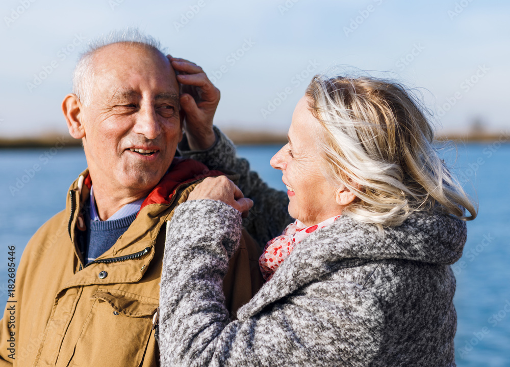 Portrait of senior couple embracing each other on a sunny autumn day. Portrait of senior couple embracing each other on a sunny autumn day.