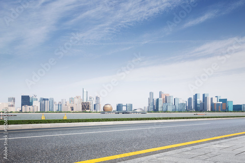 empty asphalt road with modern cityscape