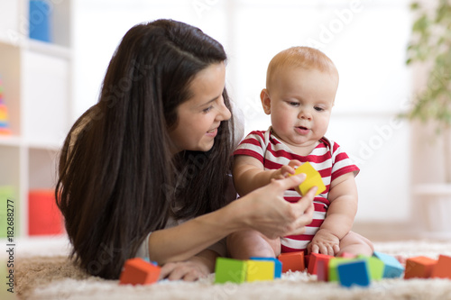 Mother with baby boy playing at home