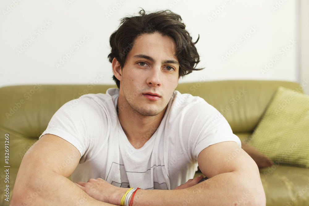 Young man sitting on the sofa, pensive Young man sitting on the sofa, pensive