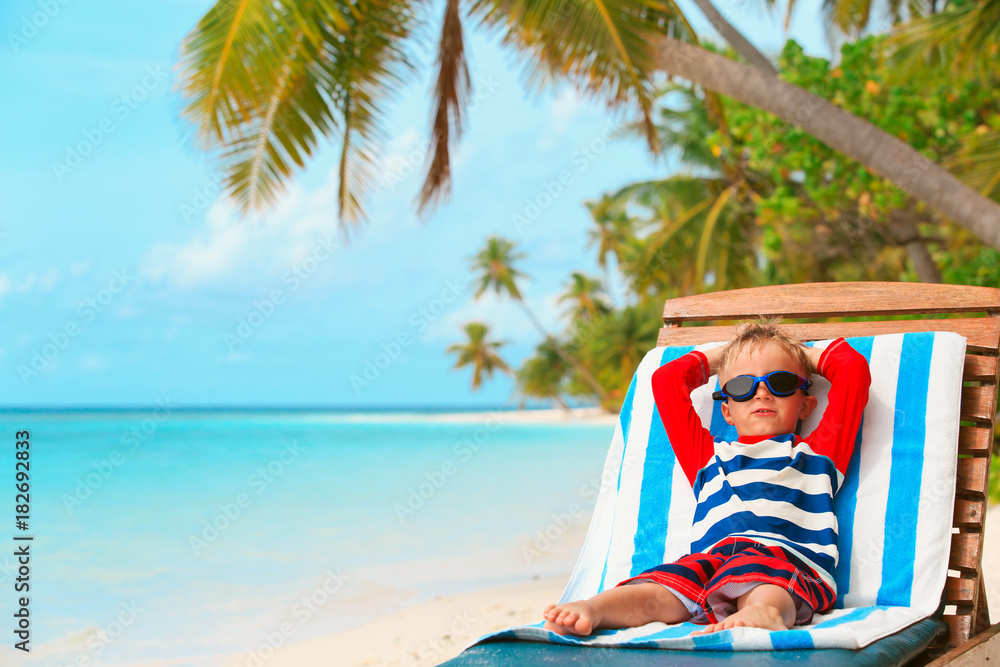 little boy relaxed on summer beach