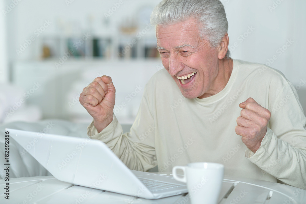 senior man using laptop senior man using laptop