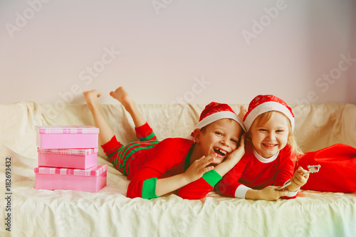 happy little boy and girl waiting for Christmas at home
