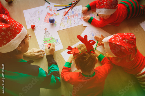 father and kids making Christmas crafts, family celebration