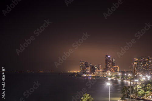 The ships and buildings with colourful lights in Pattaya bay 's area,Thailand. Its a tourist attraction primarily for night life and entertainment.