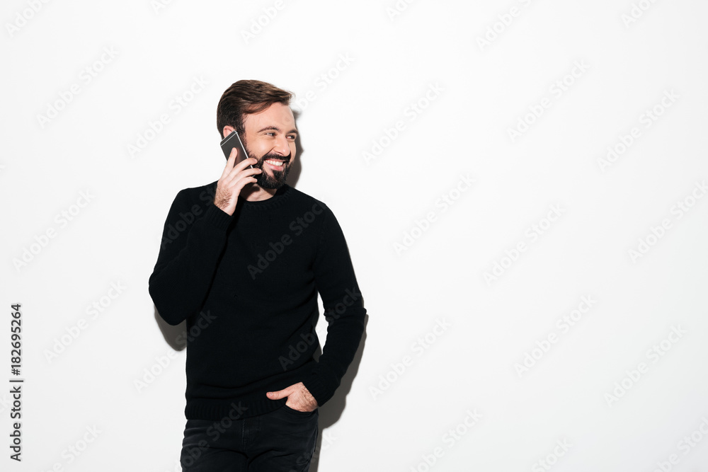 Portrait of a cheerful bearded man talking on mobile phone Portrait of a cheerful bearded man talking on mobile phone