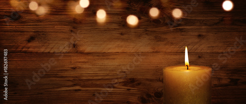 Candle with wooden wall and bokeh