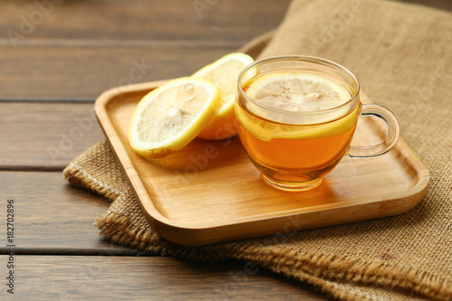 lemon black tea in glass cup on wooden table