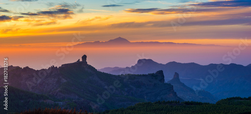 spectacular sunset over roque nublo mountain on Gran Canaria, in the background visible volcano Teide on tenerife photo