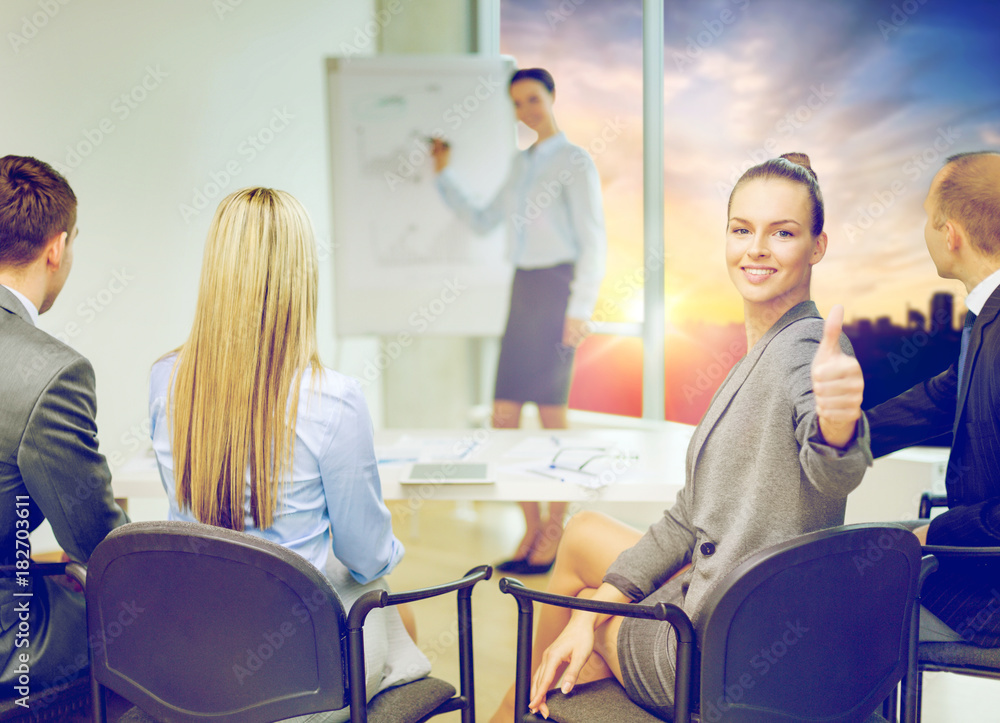 Fototapeta premium businesswoman showing thumbs up at office