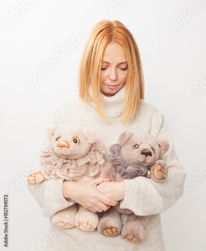 Girl with soft toy bear on white background