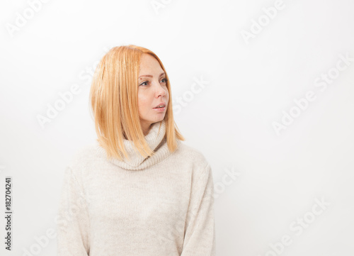 Surprised girl looking to the side white background © ekramar