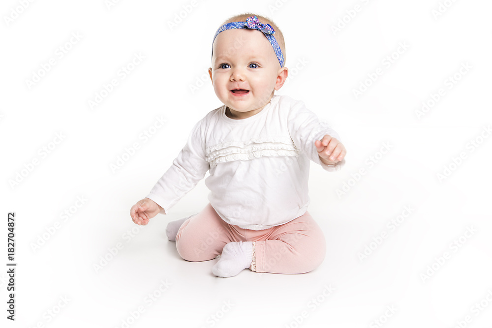 six month old baby, in front of a white background six month old baby, in front of a white background