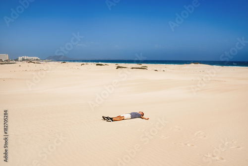 young man in the dunes in Fuerteventura, Spain